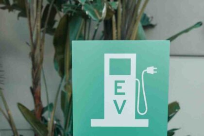 Odisha EV charging stations promotional graphic showing EV charger, electric car, temple backdrop, and state transport initiative